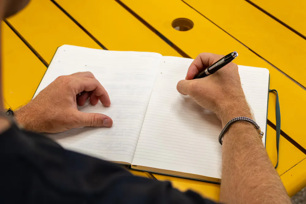 Designer sketching ideas in a notebook